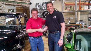 Custom car designer and TV personality Chip Foose and Revell VP and GM Lou Aguilera shake hands after signing a 3-year, six vehicle license agreement.